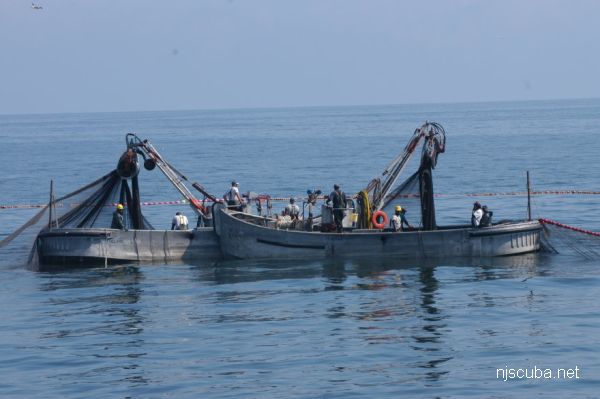 Large purse seine net being loaded onto research vessel, Cordova